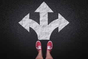 At a crossroads - Decisions and choices concept with large arrow signs